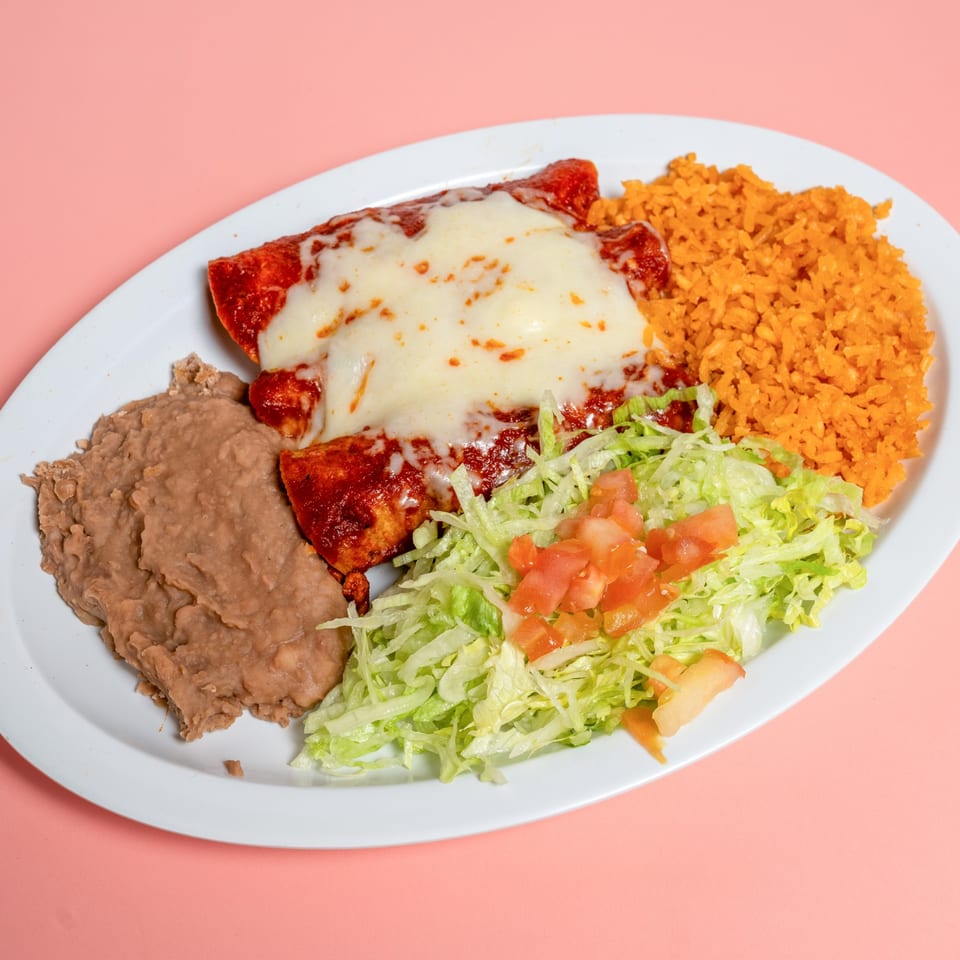 Two cheesy enchiladas with red sauce, refried beans, Mexican rice, and a side salad.